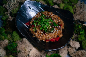 Nikkei-style fried rice with vegetables and sesame served at Paperfish Sushi, a comforting dish ideal for business dinners in Brickell